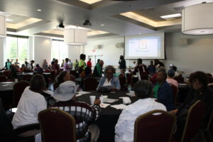 People sitting at tables eating lunch on a Soul Food Thursday at the Robert "Bob" Harrison Center in North Huntsville